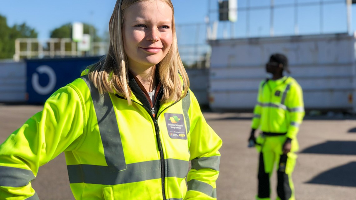 Bild på Maria Styrlander med en medarbetare i bakgrunden på en återvinningscentral